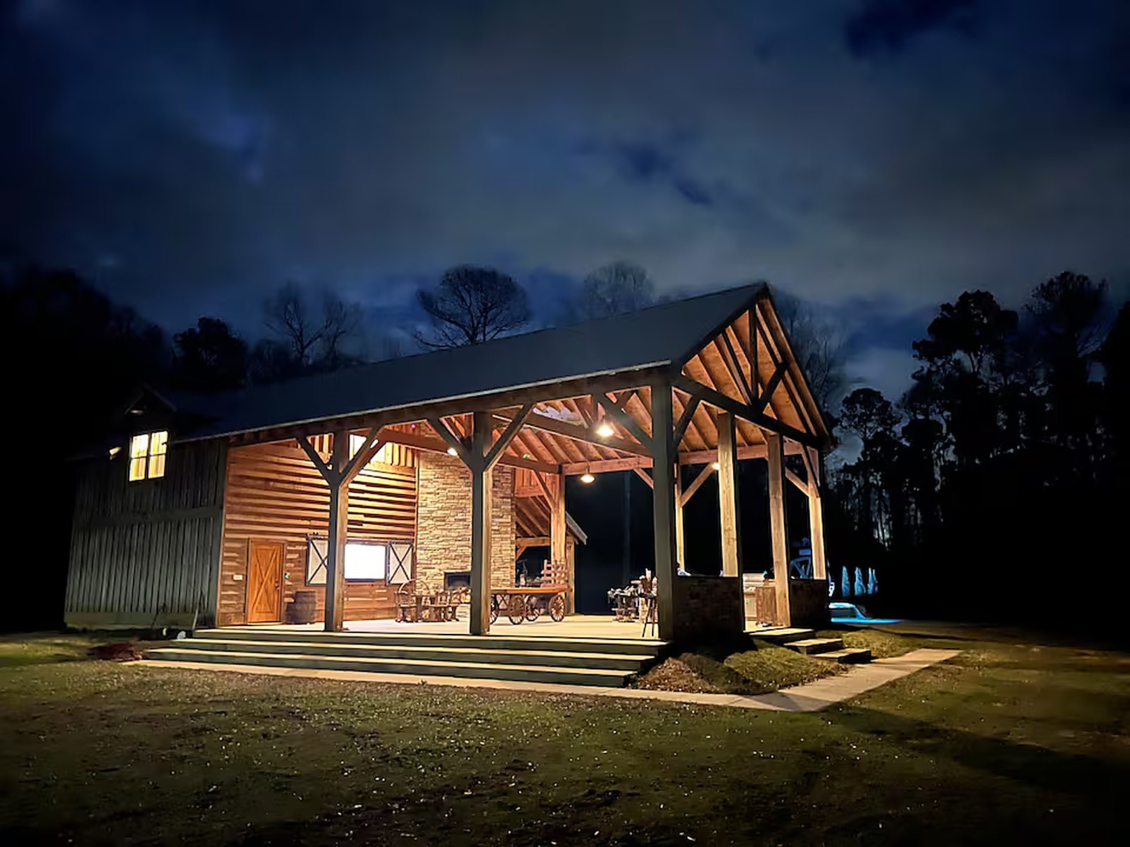 The barn lit against a night sky
