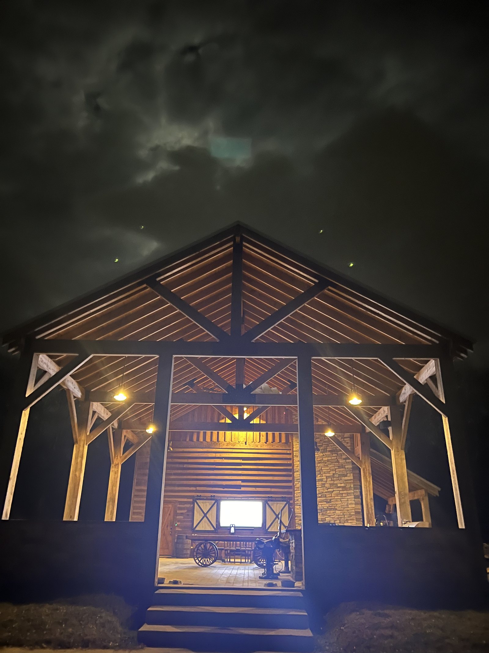 The barn, head-on, after dark